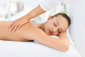 Relaxed pretty woman receiving back massage