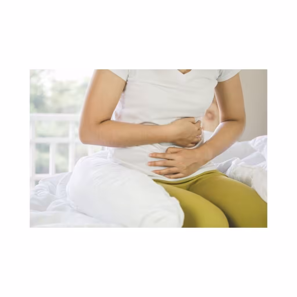 Woman holding stomach with IBS and diarrhea discomfort